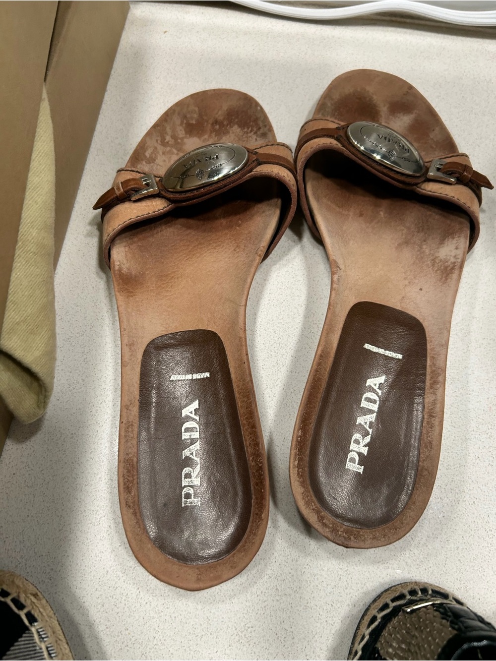Prada Tan Leather Slide Sandals with Silver-Tone Medallion